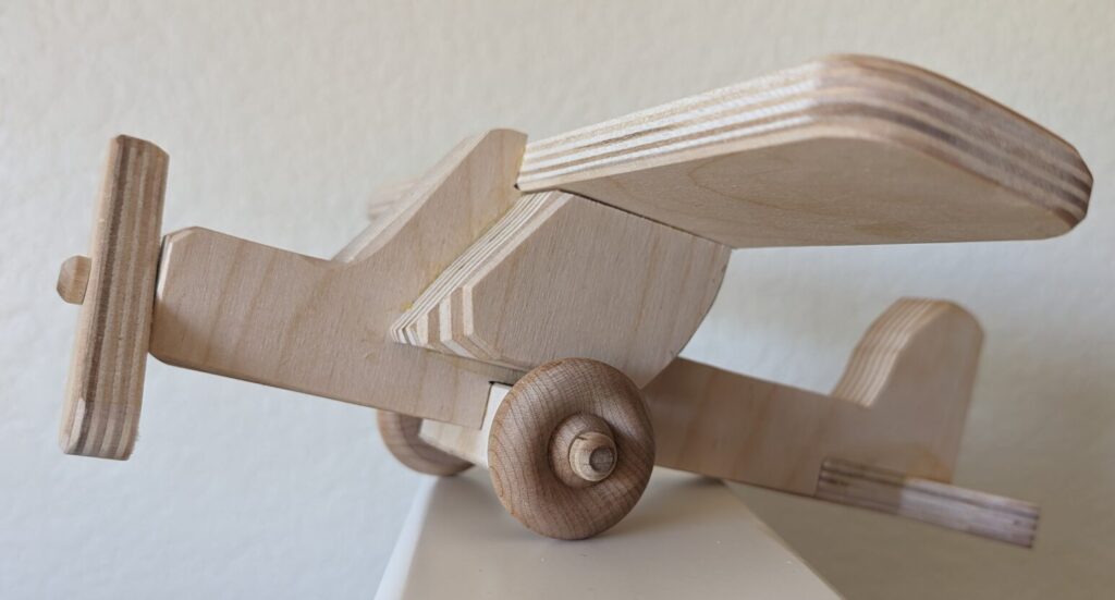 Completed wood toy monoplane on display